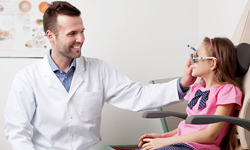 An optometrist examining a patient